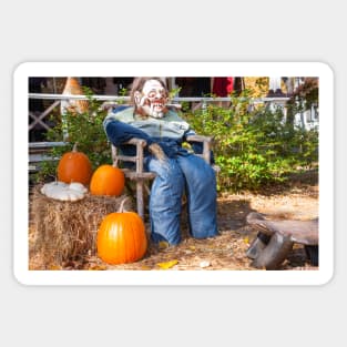 Halloween Mannequin in with ugly mask chair outside beside three large orange pumpkins Sticker